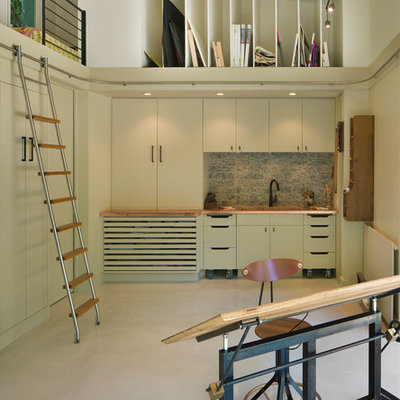 Home studio - contemporary freestanding desk concrete floor home studio idea in Austin with white walls and no fireplace