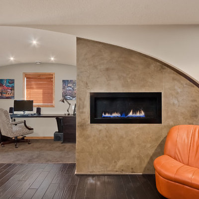Mid-sized trendy freestanding desk dark wood floor and brown floor study room photo in Minneapolis with white walls, a ribbon fireplace and a concrete fireplace