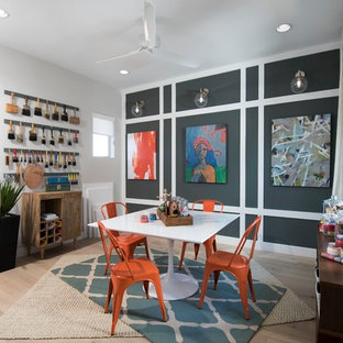 Example of a trendy light wood floor and beige floor craft room design in Phoenix with gray walls