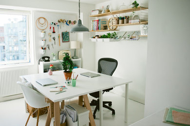 Photo of a scandinavian home office in London with white walls and a freestanding desk.