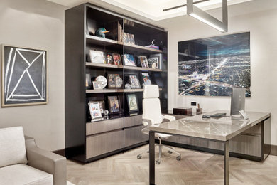 Diseño de despacho actual con paredes grises, escritorio independiente y suelo gris