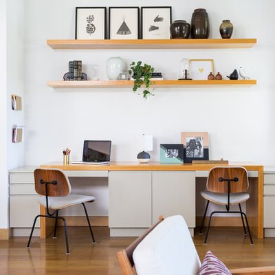 Example of a mid-sized trendy built-in desk medium tone wood floor and brown floor home office design in Los Angeles with white walls and no fireplace
