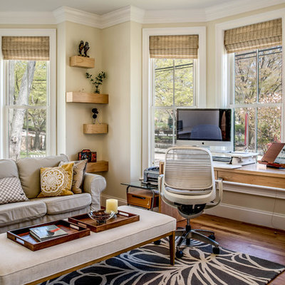 Inspiration for a large transitional freestanding desk medium tone wood floor and brown floor study room remodel in Boston with beige walls and no fireplace