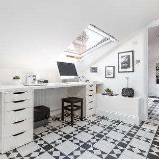 Photo of a scandi study in London with white walls, no fireplace, a built-in desk and multi-coloured floors.