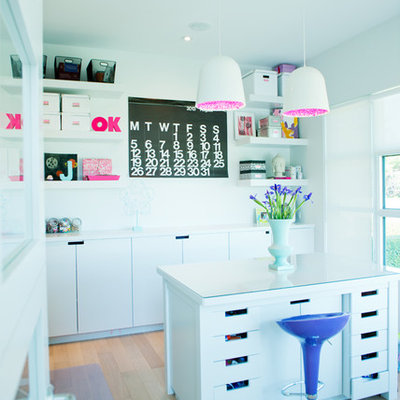 Inspiration for a contemporary freestanding desk light wood floor craft room remodel in Calgary with white walls