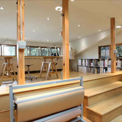 Trendy freestanding desk medium tone wood floor home studio photo in Portland with white walls