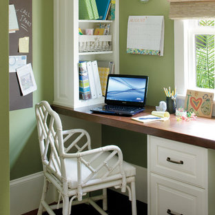 Home office - eclectic built-in desk home office idea in New Orleans with green walls
