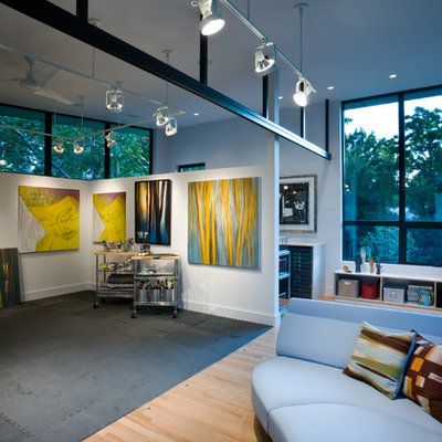 Inspiration for a contemporary medium tone wood floor home studio remodel in Dallas with white walls