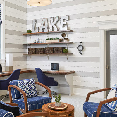 Example of a beach style built-in desk carpeted and gray floor home office design in Grand Rapids