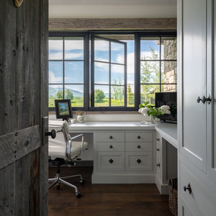 Study room - cottage built-in desk dark wood floor and brown floor study room idea in Other with white walls