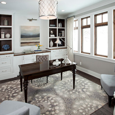 Large transitional freestanding desk dark wood floor home office photo in Minneapolis with gray walls