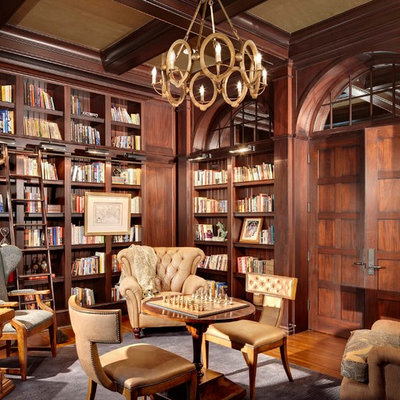 Home office library - traditional freestanding desk medium tone wood floor home office library idea in Chicago with no fireplace