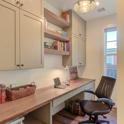 Home office - mid-sized cottage built-in desk dark wood floor and brown floor home office idea in Austin with white walls