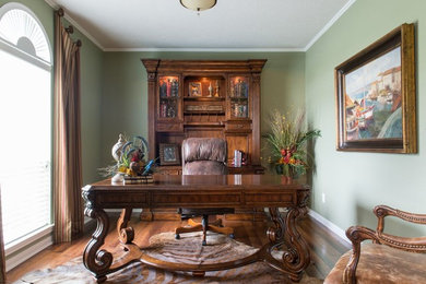 Photo of a mediterranean home office in Houston with medium hardwood flooring.