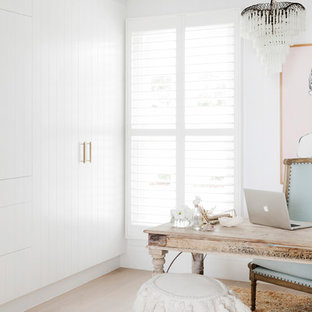 Mid-sized beach style study room in Sydney with white walls, a freestanding desk, light hardwood floors and beige floor.