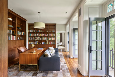 Mid-sized transitional freestanding desk light wood floor and brown floor home office library photo in Philadelphia with white walls and no fireplace