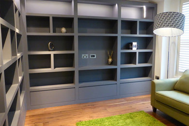 Photo of a medium sized contemporary home office in London with white walls, dark hardwood flooring and brown floors.