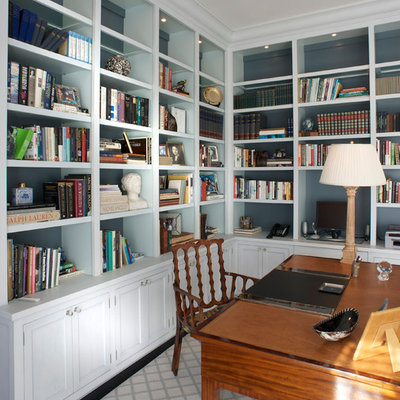 Inspiration for a mid-sized timeless freestanding desk dark wood floor and brown floor home office library remodel in New York with blue walls and no fireplace