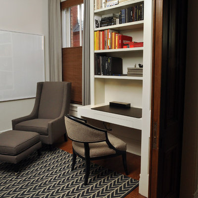 Inspiration for a mid-sized contemporary built-in desk medium tone wood floor study room remodel in Chicago with white walls
