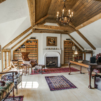 Study room - mid-sized farmhouse freestanding desk light wood floor study room idea in Dallas with white walls, a standard fireplace and a stone fireplace
