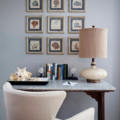 Example of a mid-sized beach style freestanding desk dark wood floor and brown floor study room design in Miami with gray walls and no fireplace