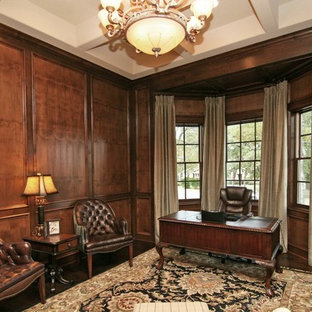 Study room - large traditional freestanding desk dark wood floor and brown floor study room idea in Austin with brown walls, a standard fireplace and a stone fireplace