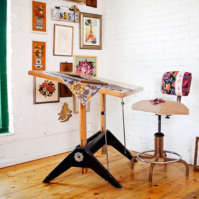 Example of an eclectic freestanding desk medium tone wood floor home studio design in Denver with white walls