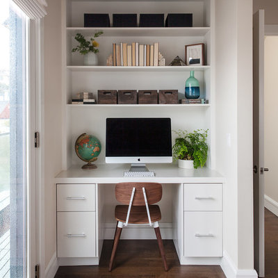 Trendy built-in desk dark wood floor study room photo in San Francisco with white walls