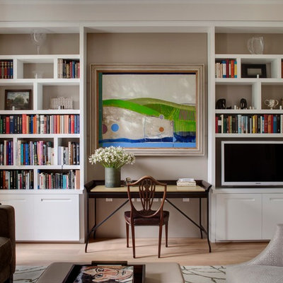 Home office library - transitional freestanding desk light wood floor home office library idea in London with gray walls