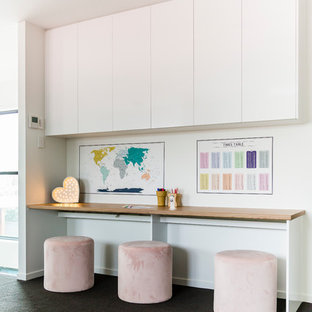 Design ideas for a contemporary study room in Sunshine Coast with white walls, carpet, a built-in desk and grey floor.
