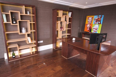 Medium sized contemporary study in Other with brown walls, dark hardwood flooring and a freestanding desk.
