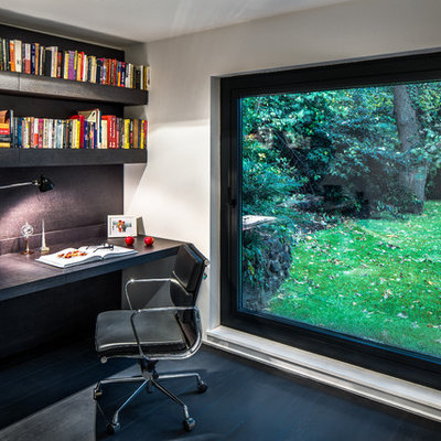 Inspiration for a contemporary built-in desk dark wood floor study room remodel in Other with white walls
