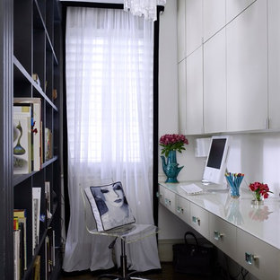 Home office library - mid-sized transitional built-in desk dark wood floor and brown floor home office library idea in London with white walls and no fireplace
