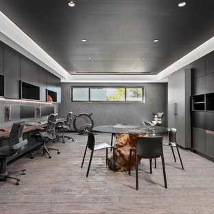 Design ideas for a contemporary study room in Perth with grey walls, medium hardwood floors, no fireplace, a built-in desk and brown floor.