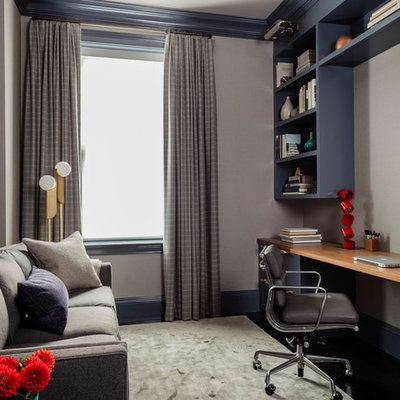 Mid-sized transitional built-in desk carpeted and gray floor study room photo in Boston with gray walls
