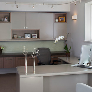 Minimalist freestanding desk carpeted home office photo in San Francisco with gray walls