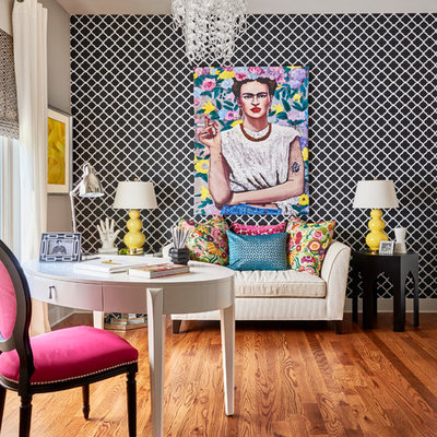 Example of a transitional freestanding desk medium tone wood floor and brown floor study room design in Charlotte with multicolored walls