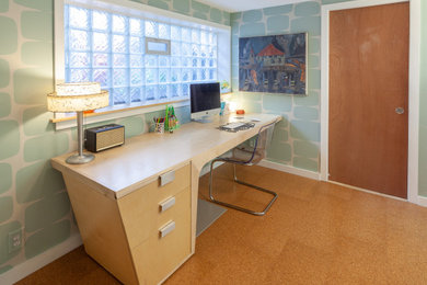 Medium sized midcentury home studio in Detroit with blue walls, cork flooring, a freestanding desk, brown floors and wallpapered walls.