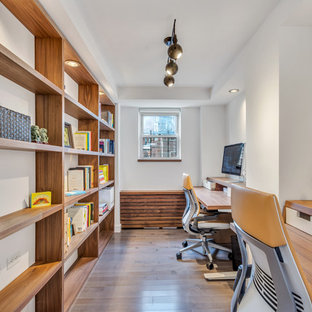 Inspiration for a mid-sized contemporary freestanding desk dark wood floor and brown floor study room remodel in New York with no fireplace and white walls