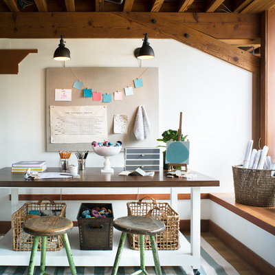 Home studio - contemporary freestanding desk medium tone wood floor home studio idea in San Francisco with white walls