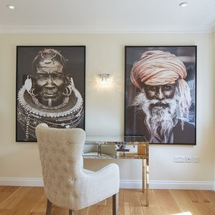 This is an example of a traditional study in Other with yellow walls, medium hardwood flooring, a freestanding desk and brown floors.