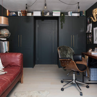 This is an example of a medium sized country home studio in Other with green walls, light hardwood flooring, a freestanding desk and beige floors.