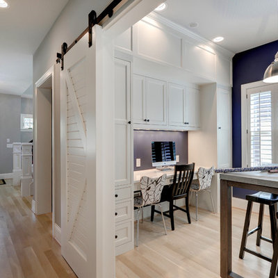 Home office - traditional built-in desk home office idea in Minneapolis with blue walls