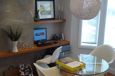 Home office - modern medium tone wood floor home office idea in Toronto with gray walls