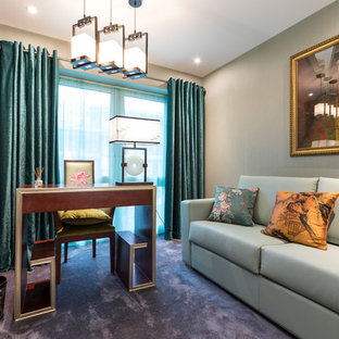 This is an example of a world-inspired study in London with multi-coloured walls, carpet, no fireplace, a freestanding desk and grey floors.