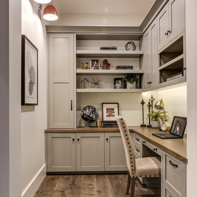 Inspiration for a transitional built-in desk medium tone wood floor and brown floor study room remodel in Phoenix with white walls and no fireplace