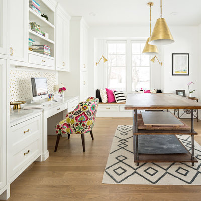 Farmhouse built-in desk medium tone wood floor and brown floor study room photo in Salt Lake City with white walls and no fireplace