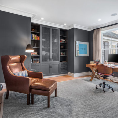 Mid-sized transitional freestanding desk medium tone wood floor and brown floor study room photo in New York with gray walls and no fireplace