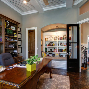 Home office - traditional freestanding desk dark wood floor home office idea in Dallas with gray walls