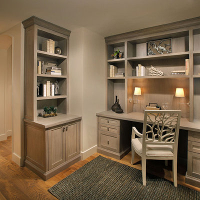 Study room - mid-sized traditional built-in desk medium tone wood floor and brown floor study room idea in Miami with beige walls and no fireplace